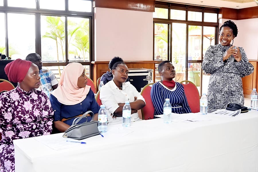 On the left, Ms Nanziri Juliet (standing above), a community member from cornor zone