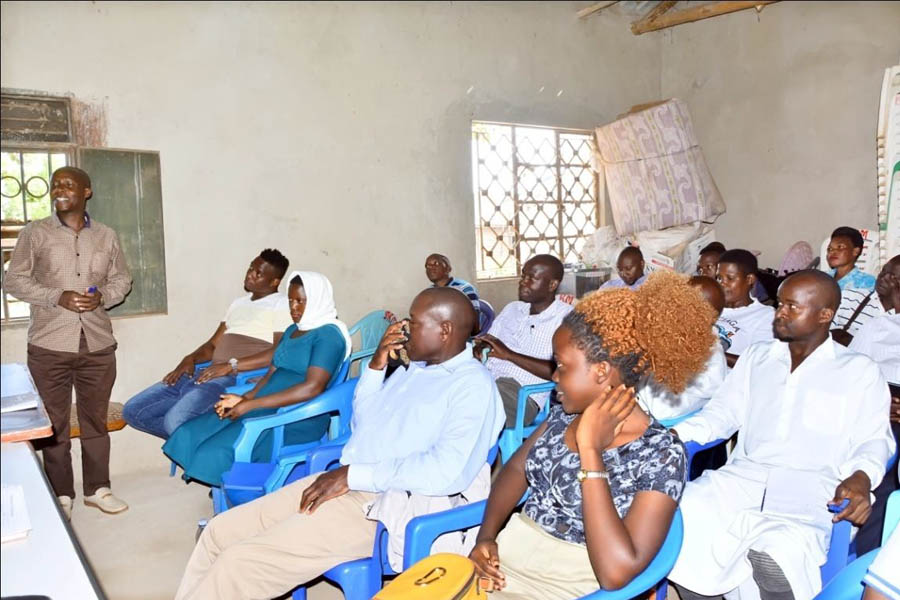 Mr. John Ngabirano, the Project Manager of Pan African Club (standing above)making closing remarks of the community meeting