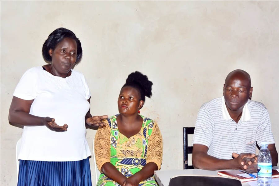 Ms Proscovia Namakula, the Women’s Leader (Nabakyala) of Corner zone (standing left above) addressing the community meeting again